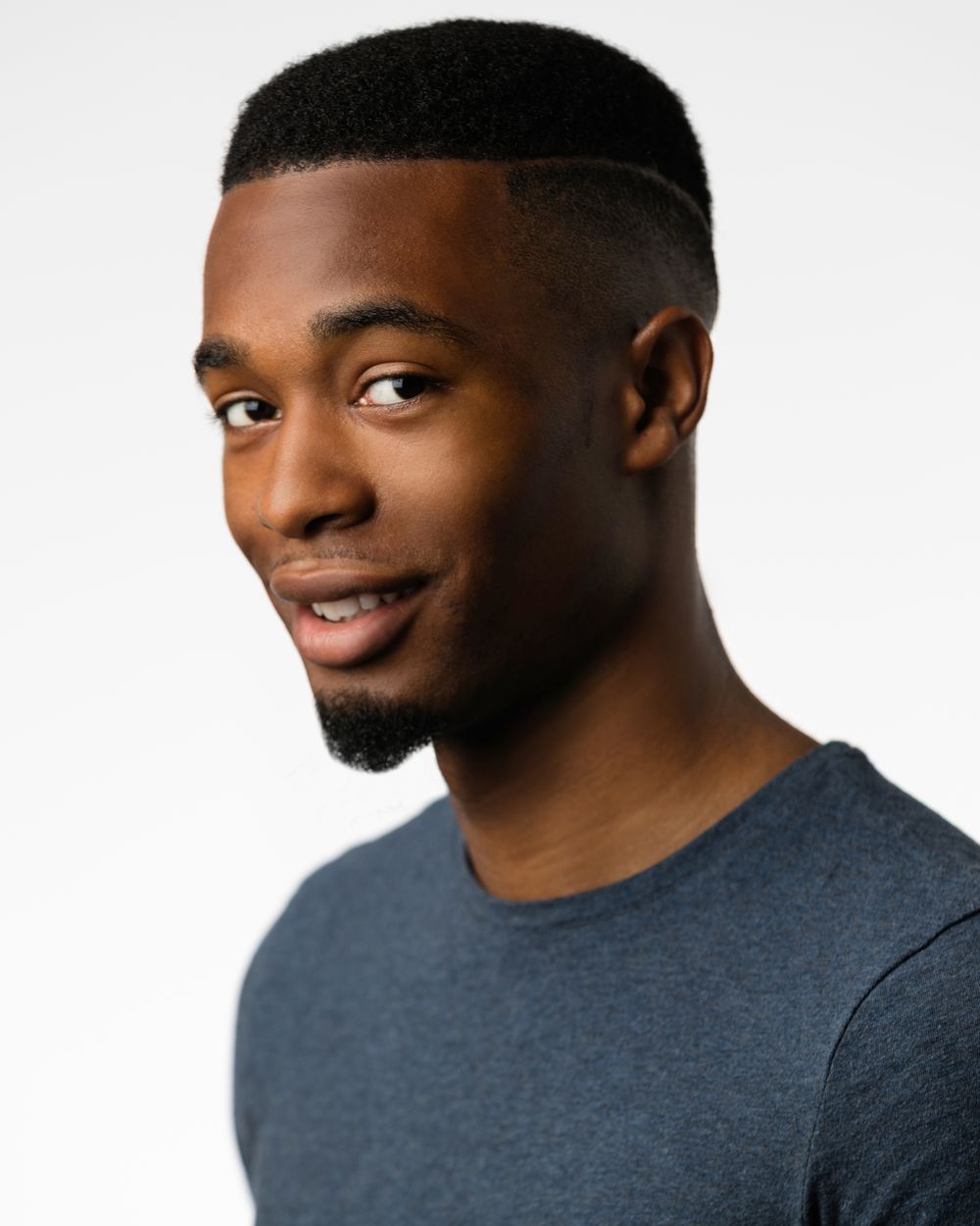 Commercial actor headshot with a natural smile on a white backdrop, HeadshotDC Washington, DC