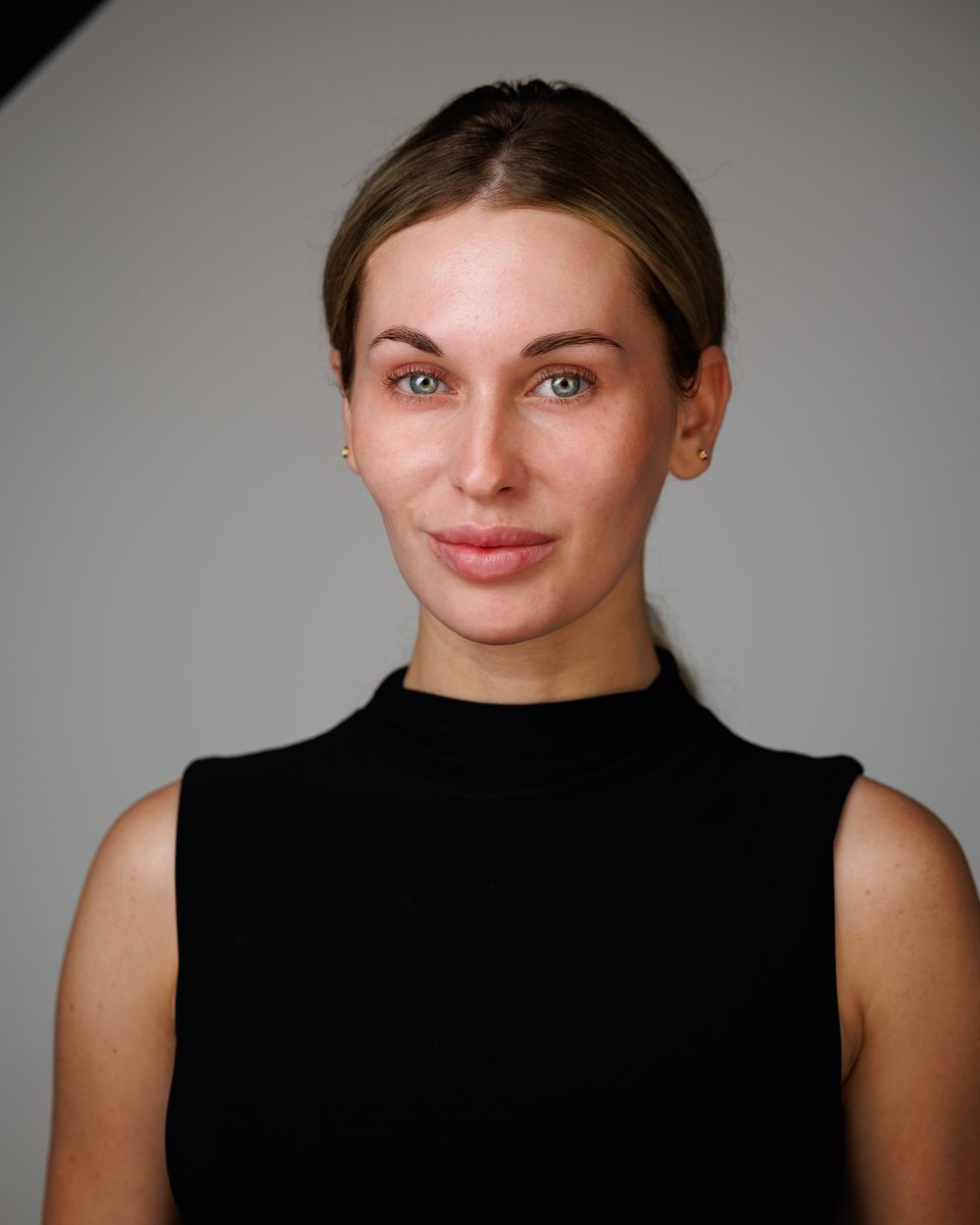 Natural, minimal-makeup actress headshot on a gray backdrop for casting digitals, HeadshotDC